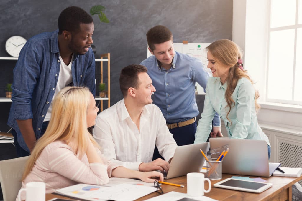 Company coworkers discussing ideas and brainstorming in office, young successful team planning new marketing strategy, copy space